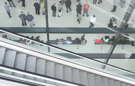 ZAGREB AIRPORT - 24 APRIL 2017: Aerial view of passengers waiting in hall, escalators passing.のeditorial素材