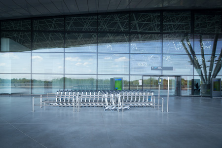 ZAGREB AIRPORT - 24 APRIL 2017: Trolley stand at the entrance of the departures terminal.のeditorial素材