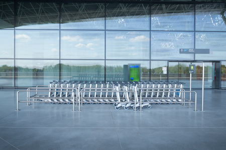 ZAGREB AIRPORT - 24 APRIL 2017: Trolley stand at the entrance of the departures terminal.のeditorial素材