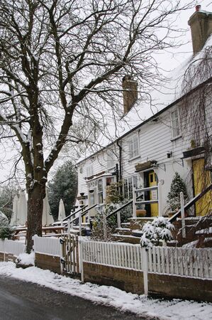 House in the snow from the roadの写真素材