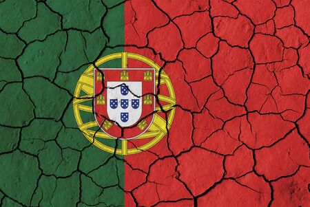 Flag of Portugal over cracked background, conceptual image of crisisの写真素材
