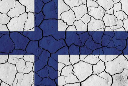 Flag of Finland over cracked background, conceptual image of crisisの写真素材