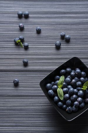 Blueberries in black bowlの写真素材