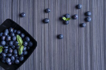 Blueberries in black bowlの写真素材