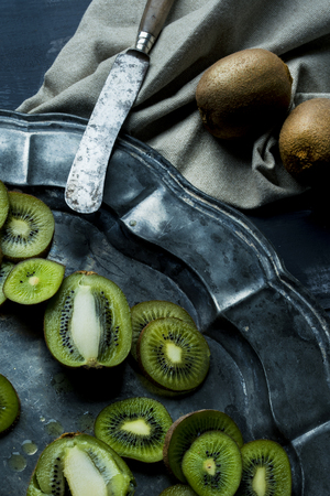 Kiwis in dark background texturedの写真素材