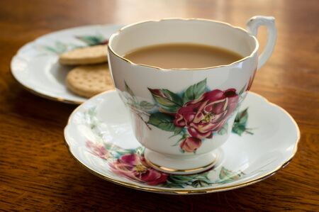 Relaxing cup of tea on a hard wood table.の写真素材