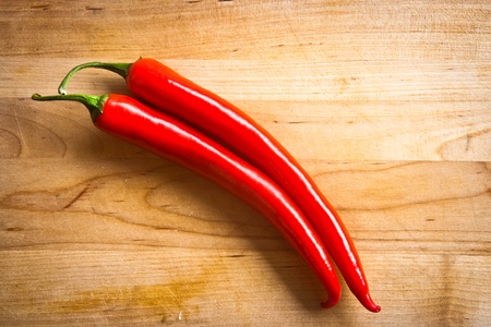 chili peppers on wooden surfaceの写真素材