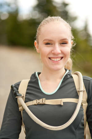 outdoor portrait of young beautiful woman while hikingの写真素材