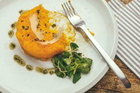 classic italian saffron risotto alla milanese served with parmesan cheese and corn salad plantの写真素材