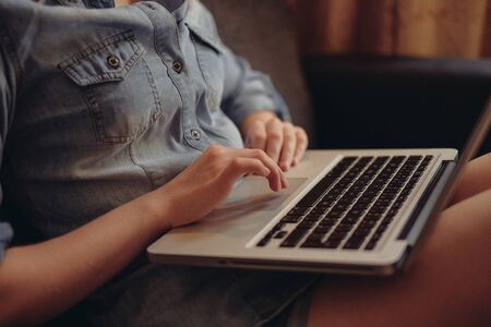 young female student working on her laptop at homeの写真素材