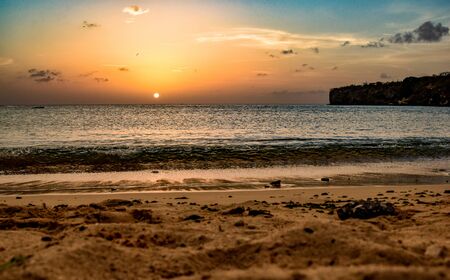 sunset over the caribbean sea at a sandy beachの写真素材