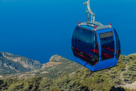 Cable car cabin in the mountains against the blue sea on a sunny summer dayの写真素材