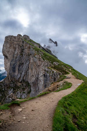 A gravel road to the peaks of the beautiful mountains of seceda.の写真素材