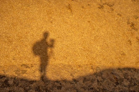 Shadow of a hiker during sunrise in Namibiaの写真素材
