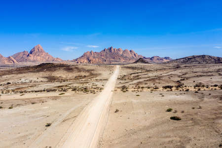 Gravel road to the mountains of spitzkoppeの写真素材