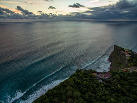 View of Uluwatu cliff with pavilion and blue sea in Bali, Indonesiaの写真素材