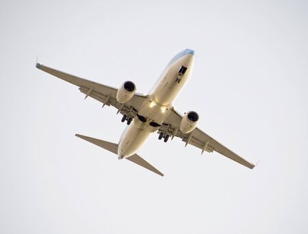 Passenger aircraft with landing gear down approaching airport