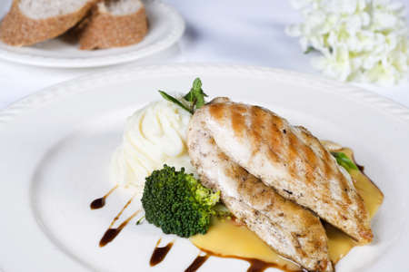 Closeup detail of a grilled chicken breast a la carte mealの写真素材