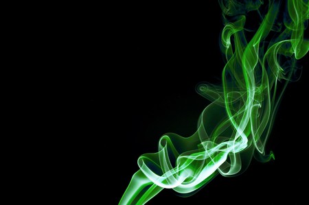 Abstract green smoke trails on a black backgroundの写真素材