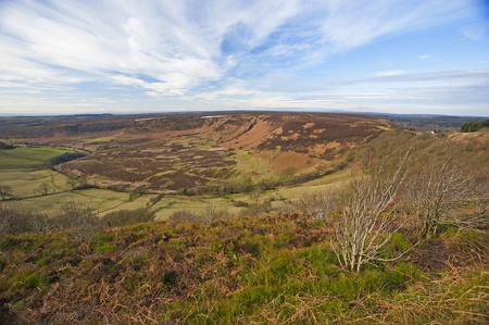 View over a valley in the english countryside with a cloudy skyの写真素材