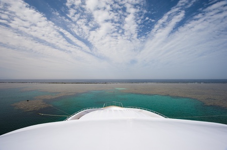 View from the bow of a large private motor yacht on tropical sea with cloudy skyの写真素材