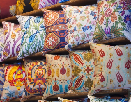 Display of ornately decorated cushions at an indoor market stallの写真素材