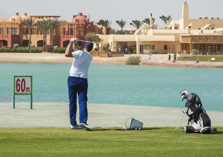 Male golfer training on a driving rangeのeditorial素材