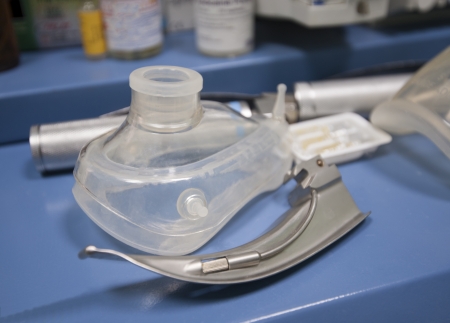 Closeup detail of a plastic oxygen mask on table in operating roomの写真素材