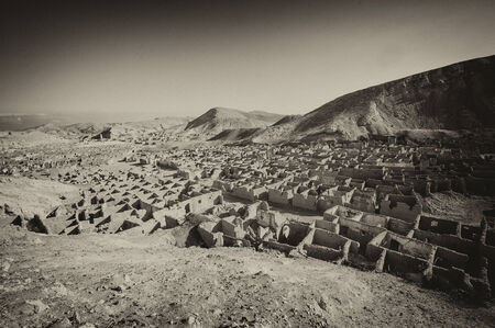 Panorama over an abandoned ghost town in desert mountains in antique sepia styleの写真素材