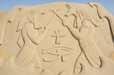 Large sand sculpture statue of egyptian hieroglyphic carvings from ancient temple in Luxor at sand city theme parkの写真素材