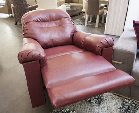 Red leather reclining armchair in furniture show roomの写真素材