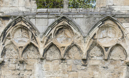 Ancient medieval church ruins against blue sky in english city centerの写真素材