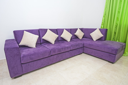 Closeup of purple sofa interior design in living room of luxury apartmentの写真素材