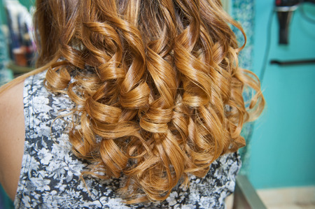 Closeup detail of female womens hair styling being styled at hairdresser salonの写真素材