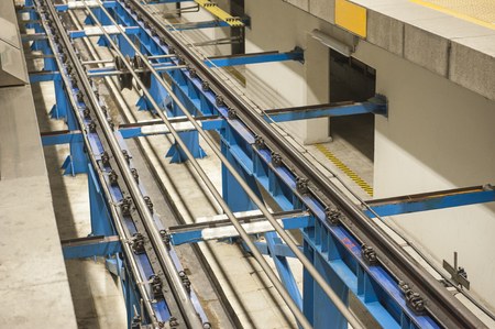 Railway tracks at a sloping underground metro train station platform