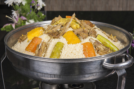Lamb meat with vegetables on an bed of couscous on display at an oriental restaurantの写真素材