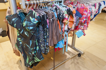 Display of womens swimwear clothing hanging in clothes shopの写真素材