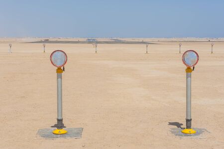 Row of approach lights off the end of an airfield airport runwayの写真素材