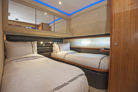 Twin beds in cabin of a luxury private motor yachtの写真素材
