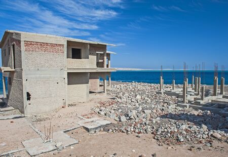 Half finished residence house on an abandoned building site at a coastal beach plot