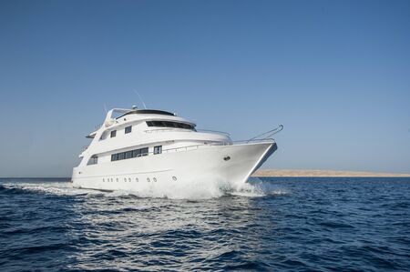 Large luxury motor yacht under way sailing out at seaの写真素材