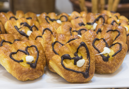 Selection display of sweet pastry dessert food with chocolate at a luxury restaurant buffet bar areaの写真素材