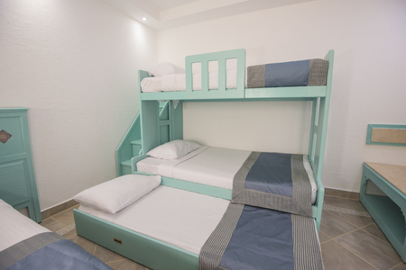 Wooden bunk beds in family room of a luxury hotel resort with stepsの写真素材
