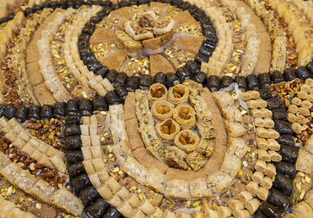 Selection display of sweet oriental pastry petit four food with baklava at a luxury restaurant buffet bar areaの写真素材
