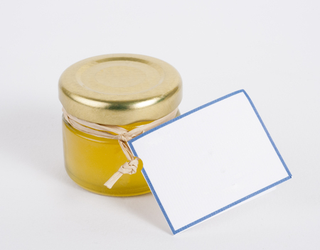 Small glass product jar with blank label for adding text isolated on a white backgroundの写真素材