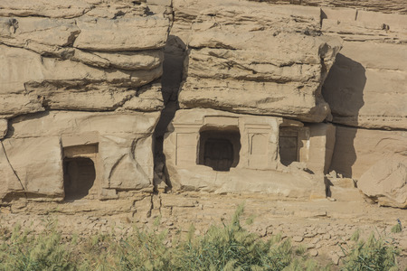 View from the Nile Rive of Gebel el Silsila mountain quarry tombs in Egypt at Khenu near Kom Omboの写真素材