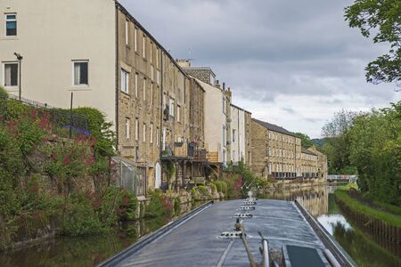 View from narrowboat traveling through English urban scenery on British canal with luxury waterfront real estate propertyの写真素材