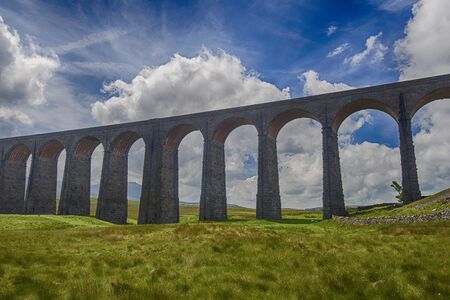 View of a large old Victorian railway viaduct across valley in rural countryside scenery panoramaの写真素材
