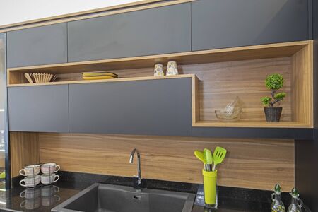 Interior design decor showing modern kitchen with cupboards in luxury apartment showroom