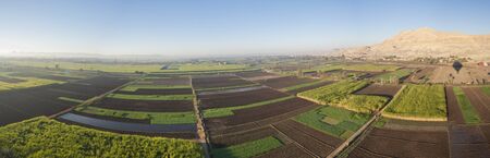 Panoramic landscape aerial view over rural countryside landscape with arable fields and meadows